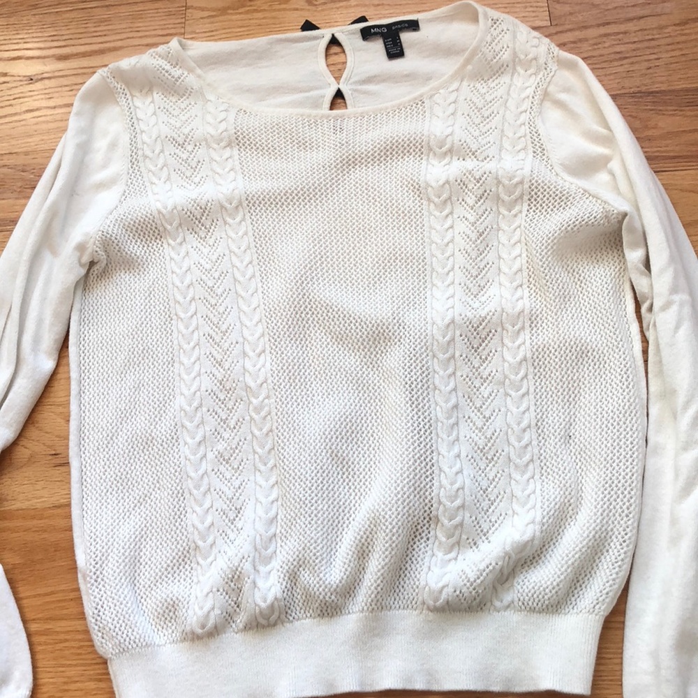 Cream sweater with black bow detail.